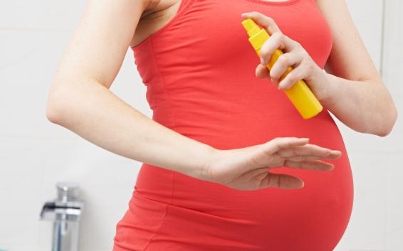 Pregnant woman with bug spray