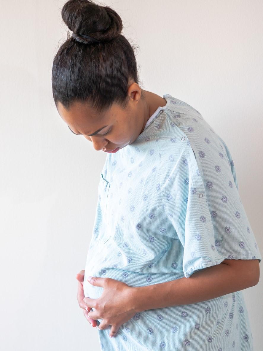 Pregnant woman in hospital gown