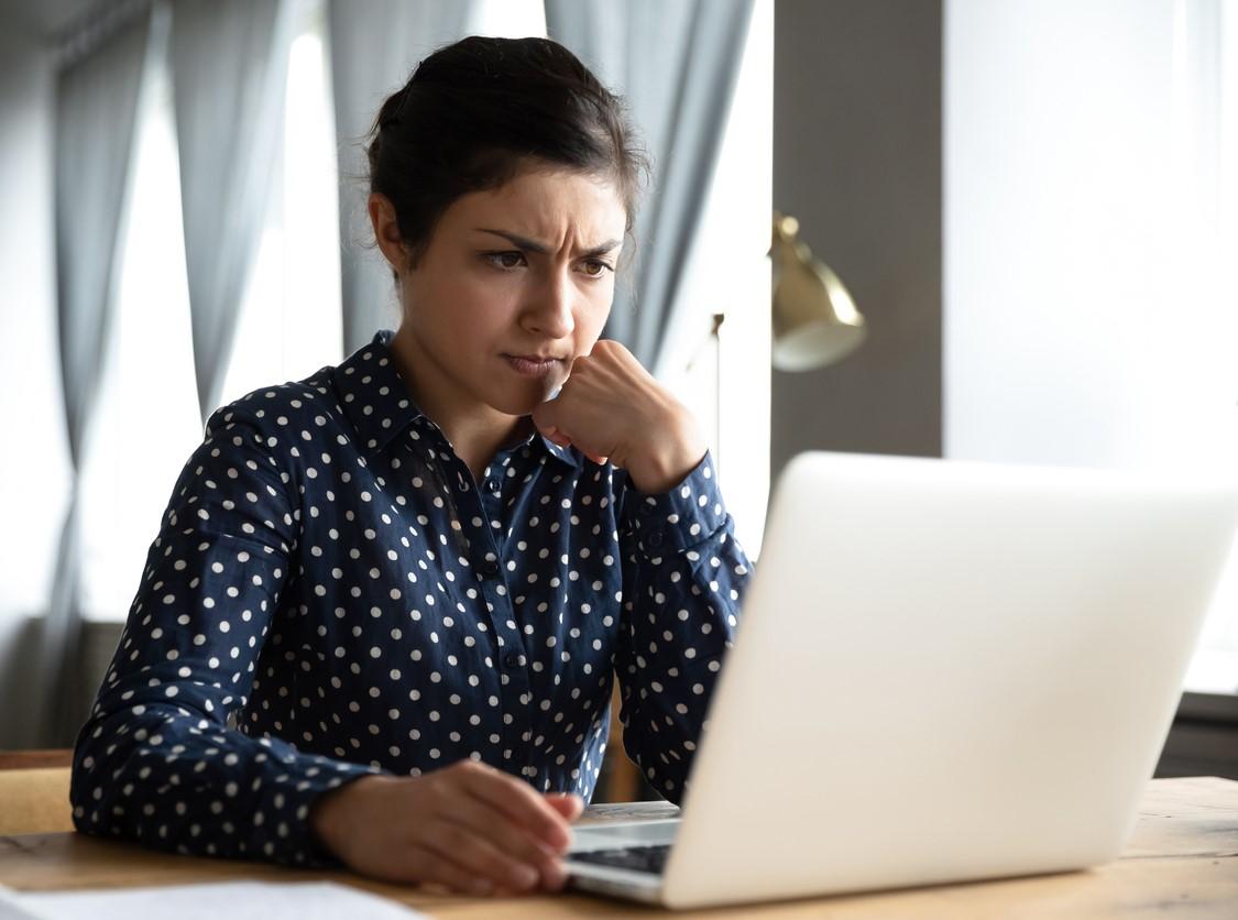 Puzzled woman at laptop