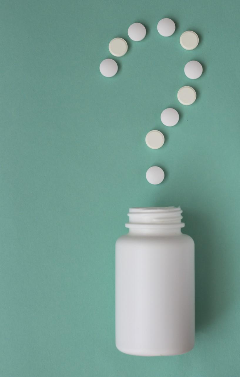 White pills in shape of question mark