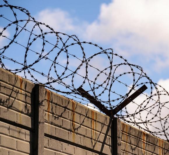 Razor wire on top of wall