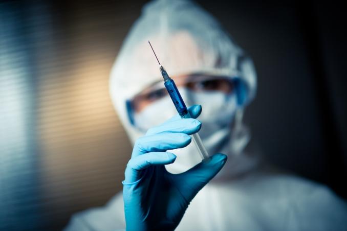 Researcher with syringe