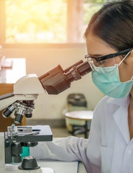 Scientist at microscope