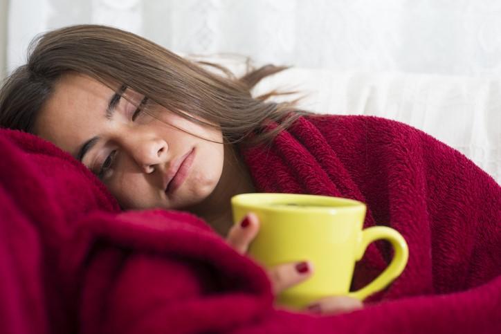 Sick woman with mug of tea