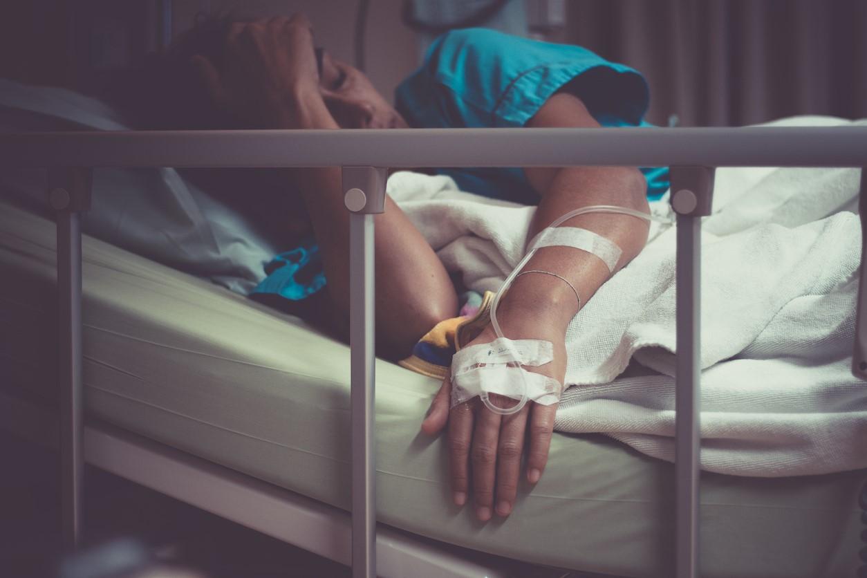 Sick woman in hospital bed