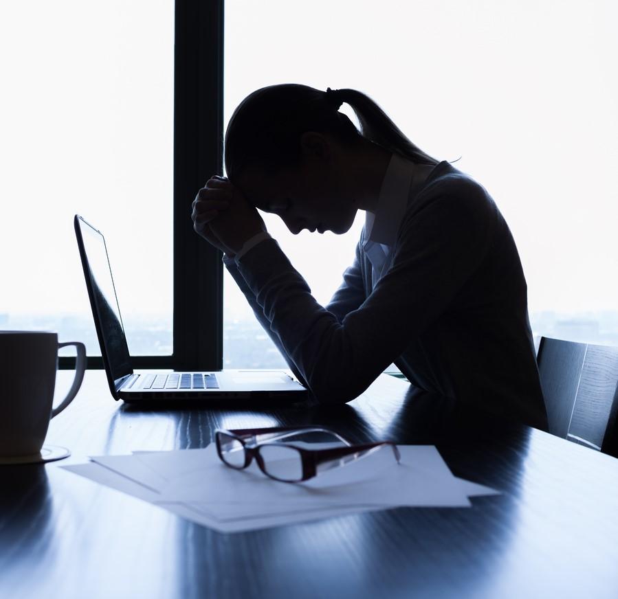 Silhouette of stressed businesswoman