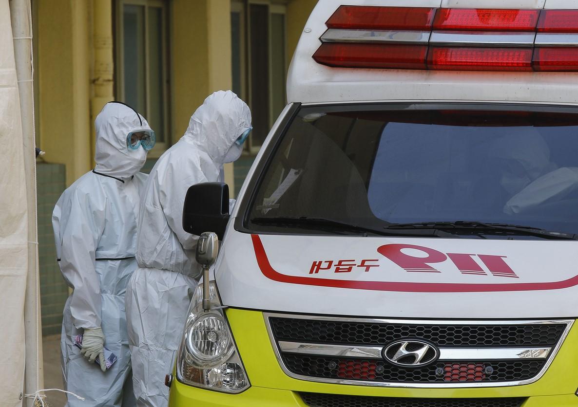 Healthcare workers outside ambulance