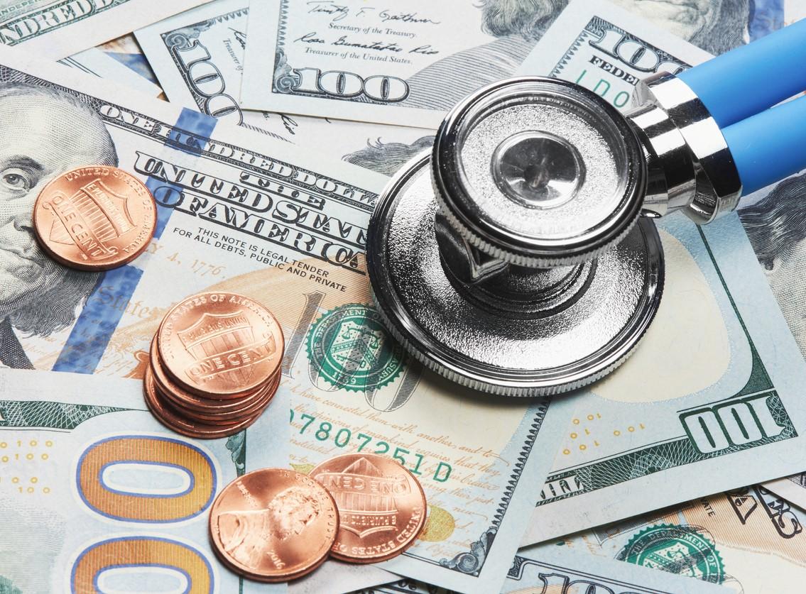 Stethoscope on a pile of money