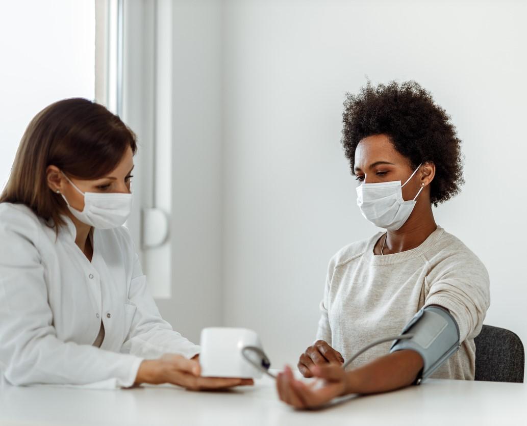 Taking woman's blood pressure