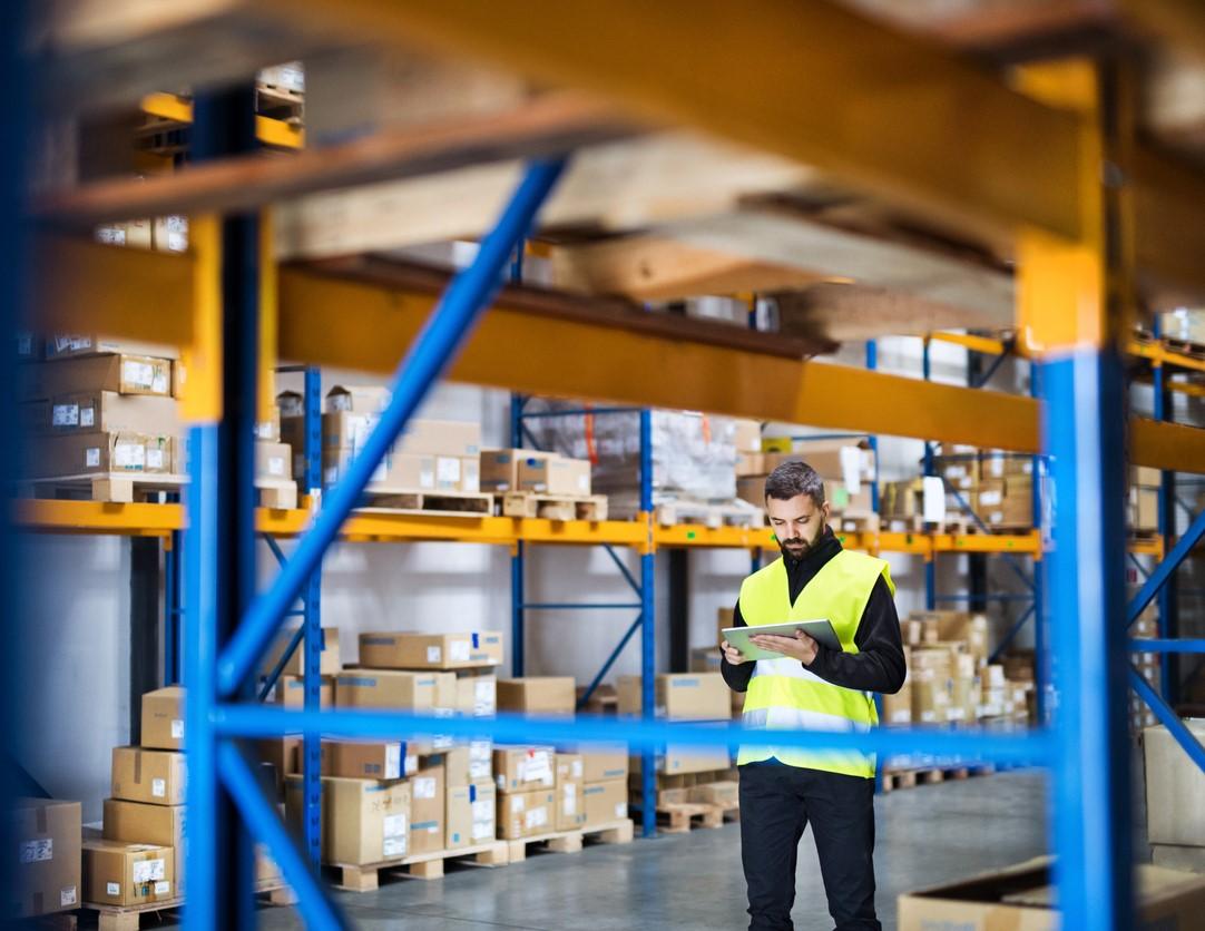 Man taking warehouse inventory