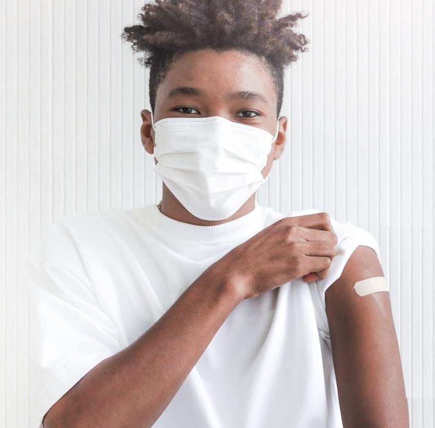 Teen boy with post-vaccine bandaid