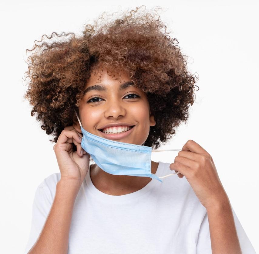 Teen girl taking off mask