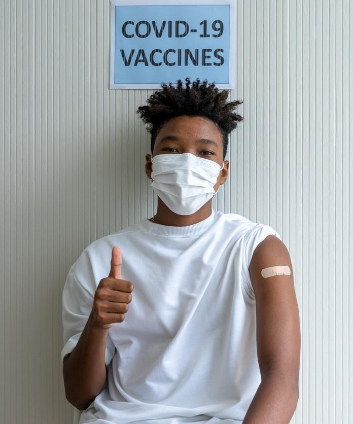 Teen with thumbs-up after vaccination