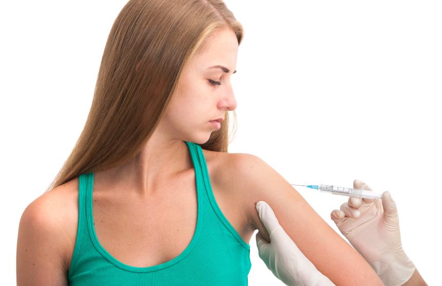 Teen receiving vaccine