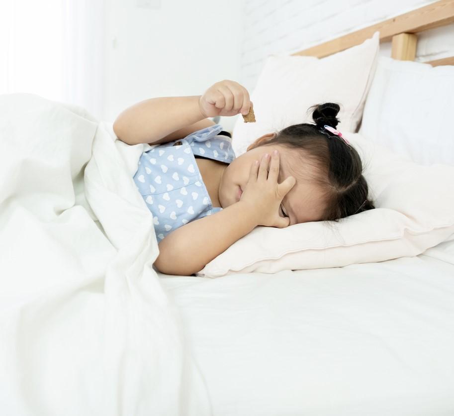 Tired little girl in bed