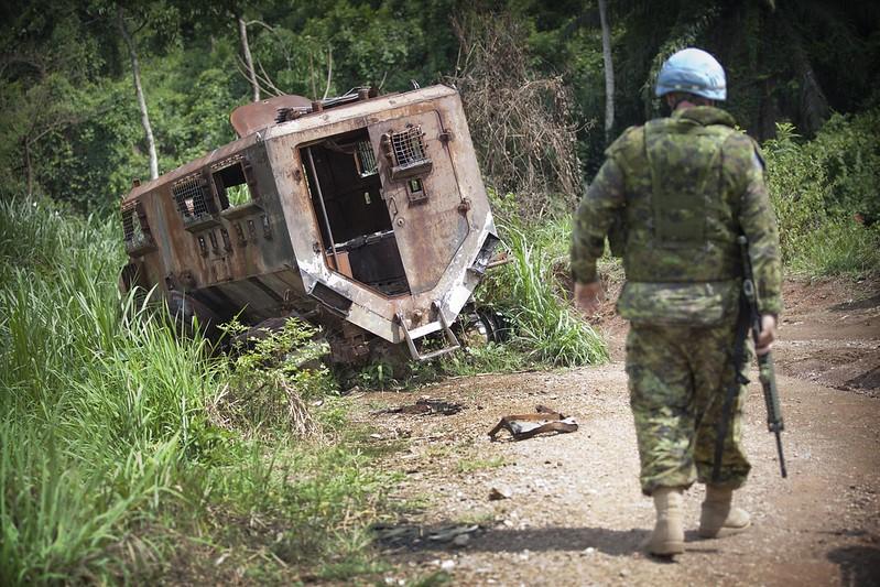 UN soldier with destroyed troop truck
