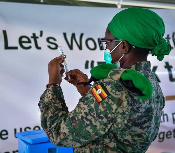 Vaccine worker with vial and syringe