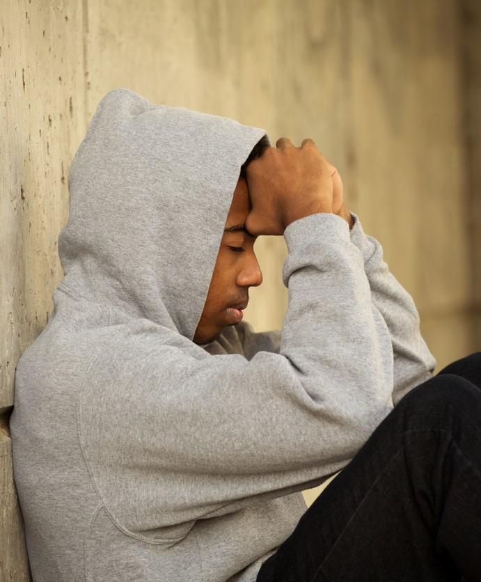 Weary young man wearing hoodie