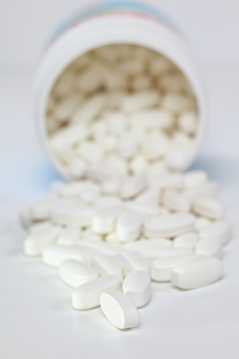 White pills spilling from container