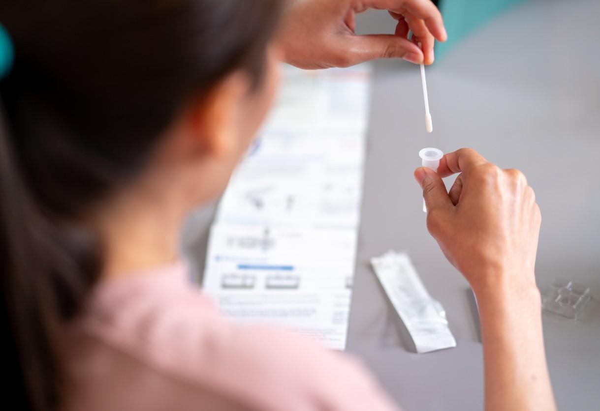 Woman conducting COVID-19 self-test