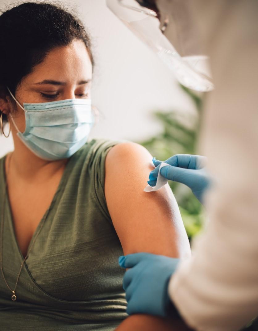 Woman getting prepped for vaccine in arm