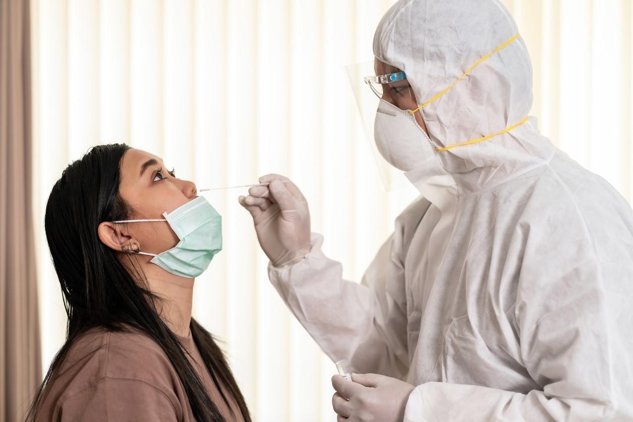 Woman with mask down getting nasal swab