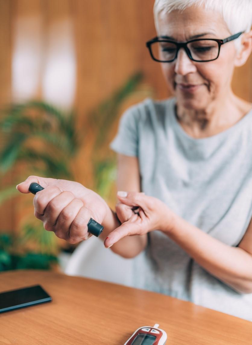 Woman monitoring her blood glucose