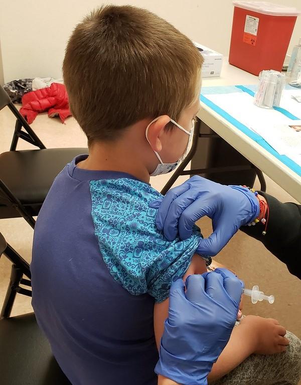 Young boy getting COVID vaccine