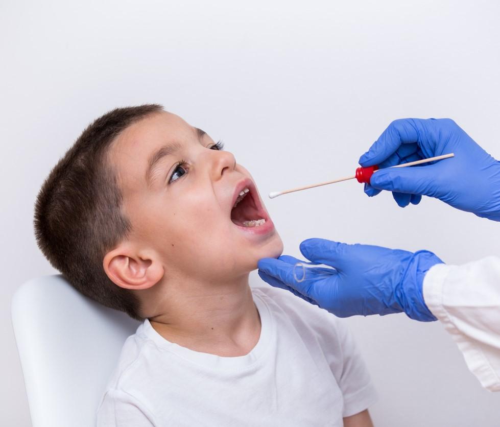 Young boy getting a throat swab