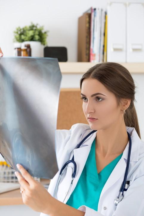 Young doctor examining x-ray