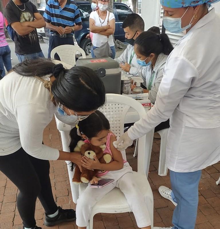Young girl getting COVID vaccine in Colombia