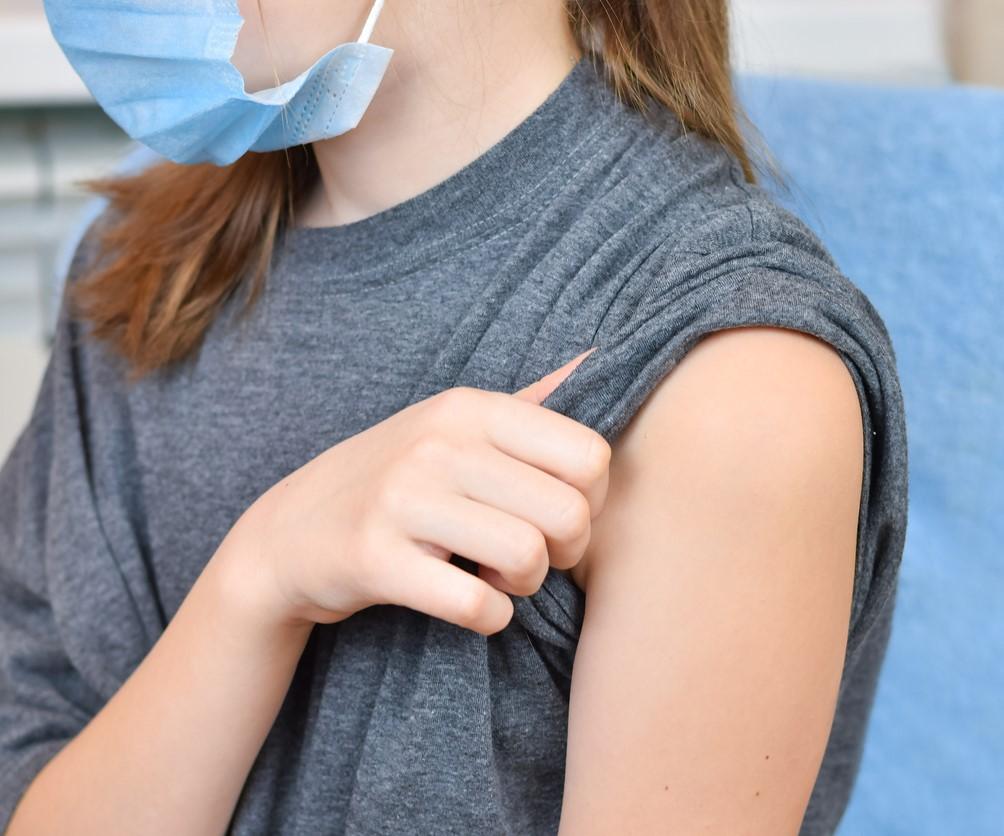 Young girl with sleeve rolled up ready for vaccine