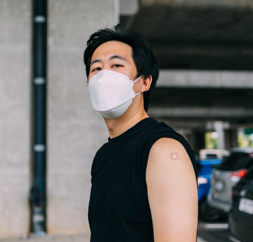 Young man with vaccine bandage