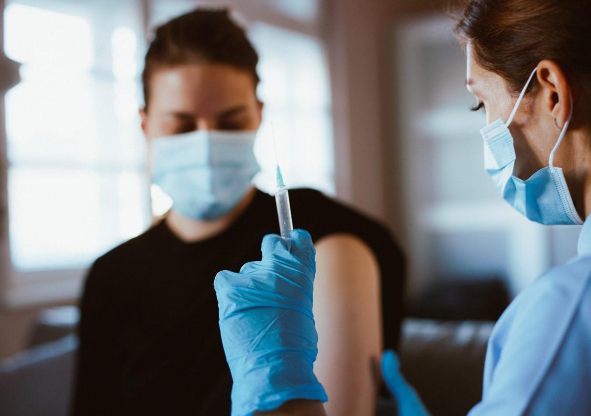 Young woman about to get vaccinated