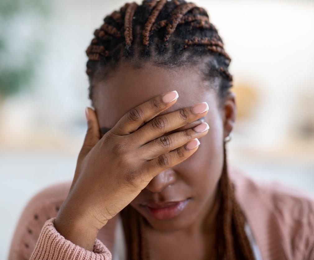 Young woman with long covid headache