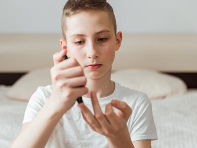 Boy checking his glucose levels