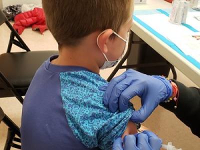 Boy receiving COVID vaccination