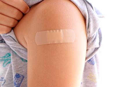 Vaccinated child with bandage on arm