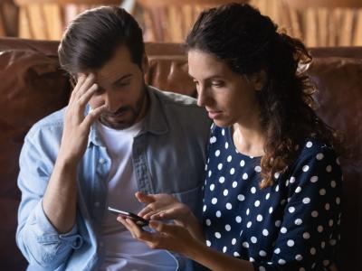 Confused couple viewing smartphone