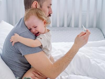 Dad holding sick baby