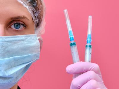 Doctor holding insulin syringes