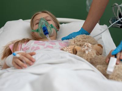 Girl with oxygen mask and teddy bear