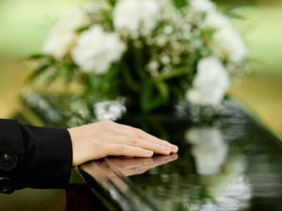 Hand on casket