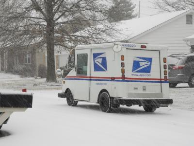 mail truck in snowstorm