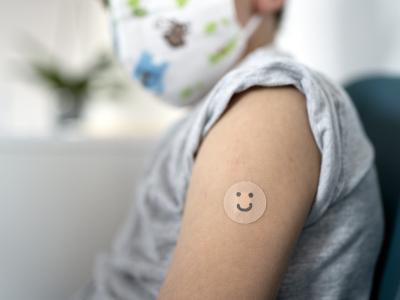 Masked boy with bandaid
