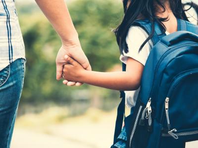Mom and schoolgirl holding hands