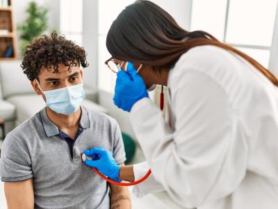 Nurse listening to heart
