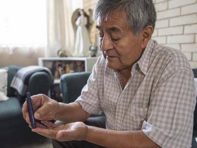 Older man checking blood sugar