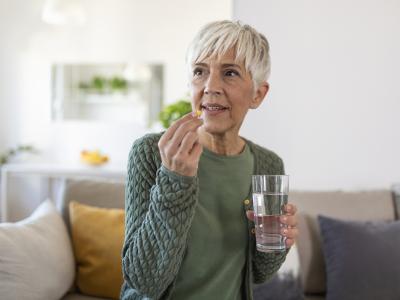 Older woman taking pill