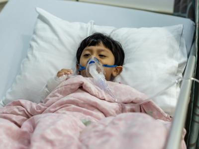 Sick boy with oxygen mask